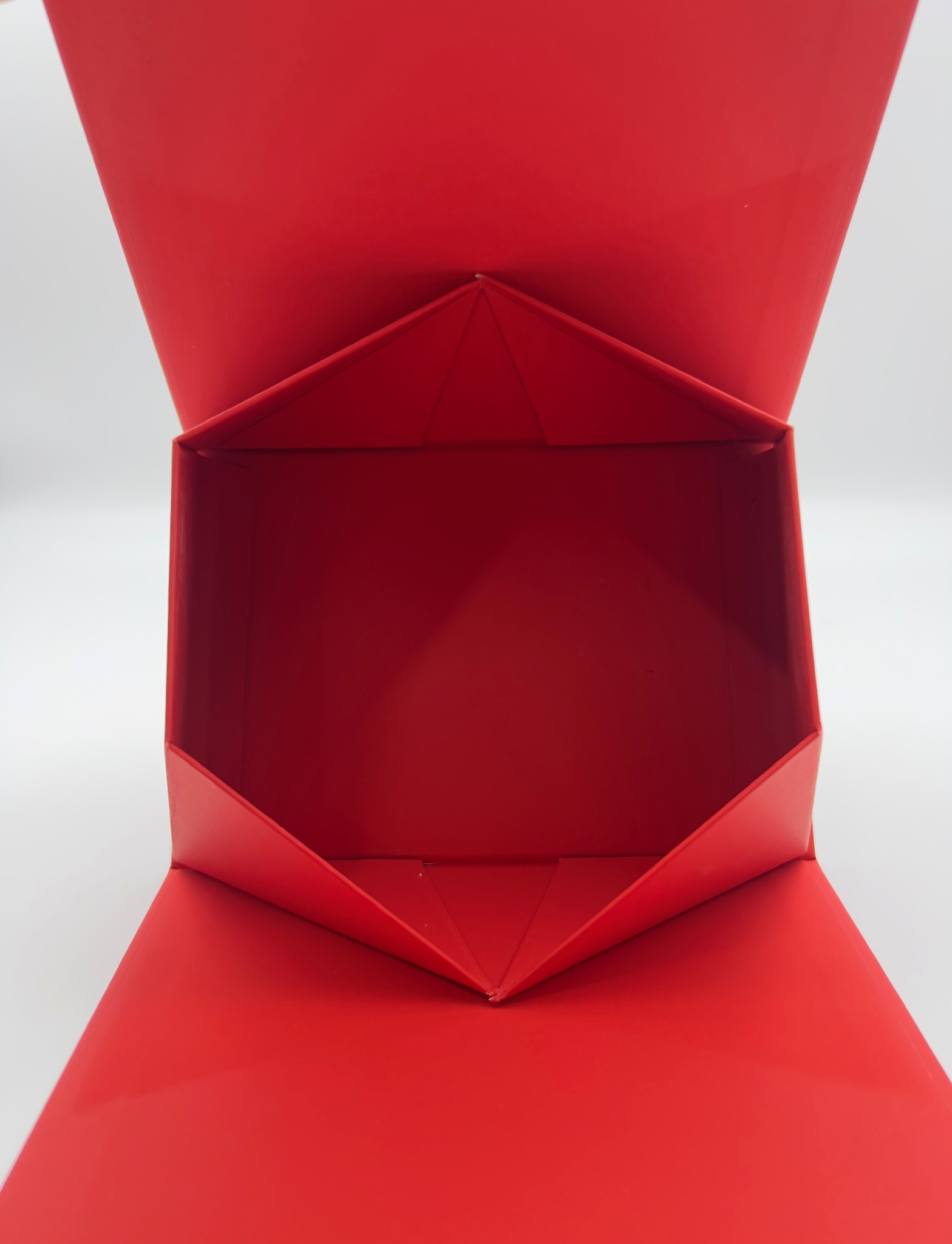 Folding triangular handheld box